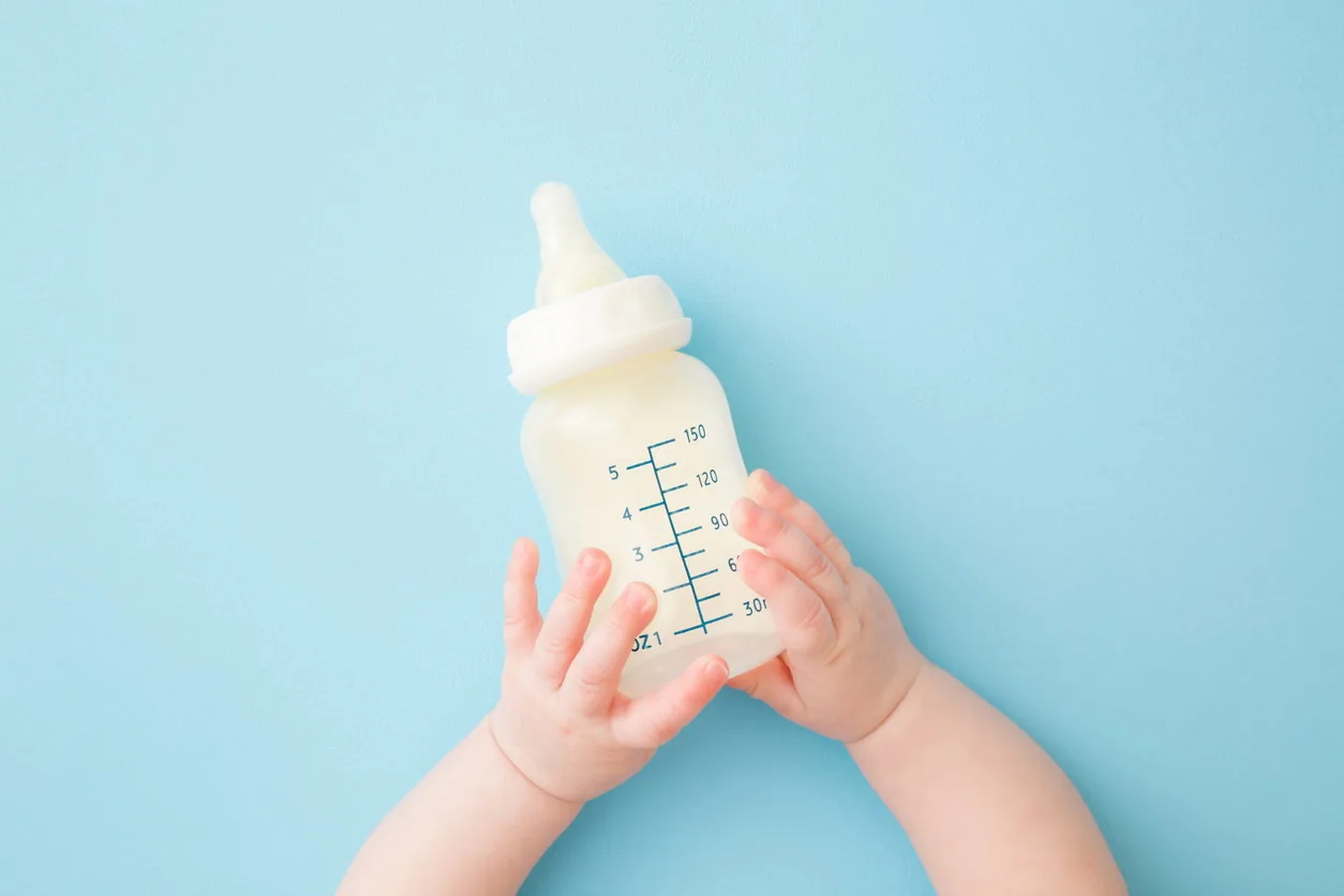 A baby feeding directly at the breast