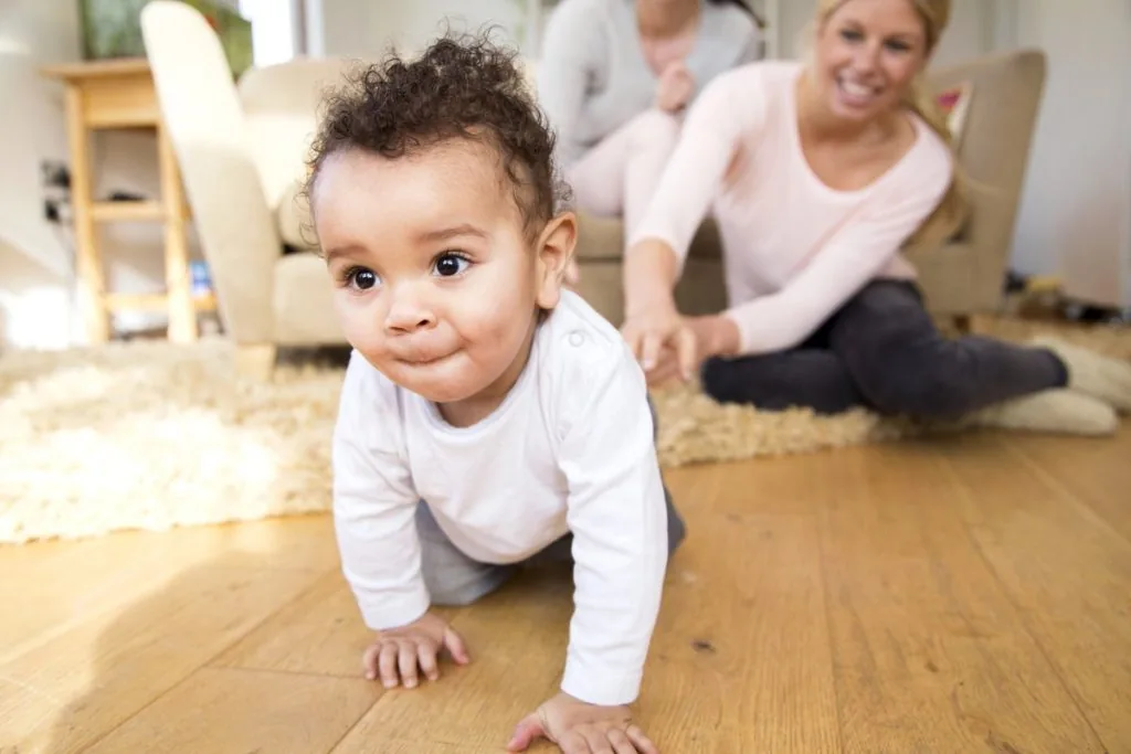 Baby lotion being applied to a baby's leg