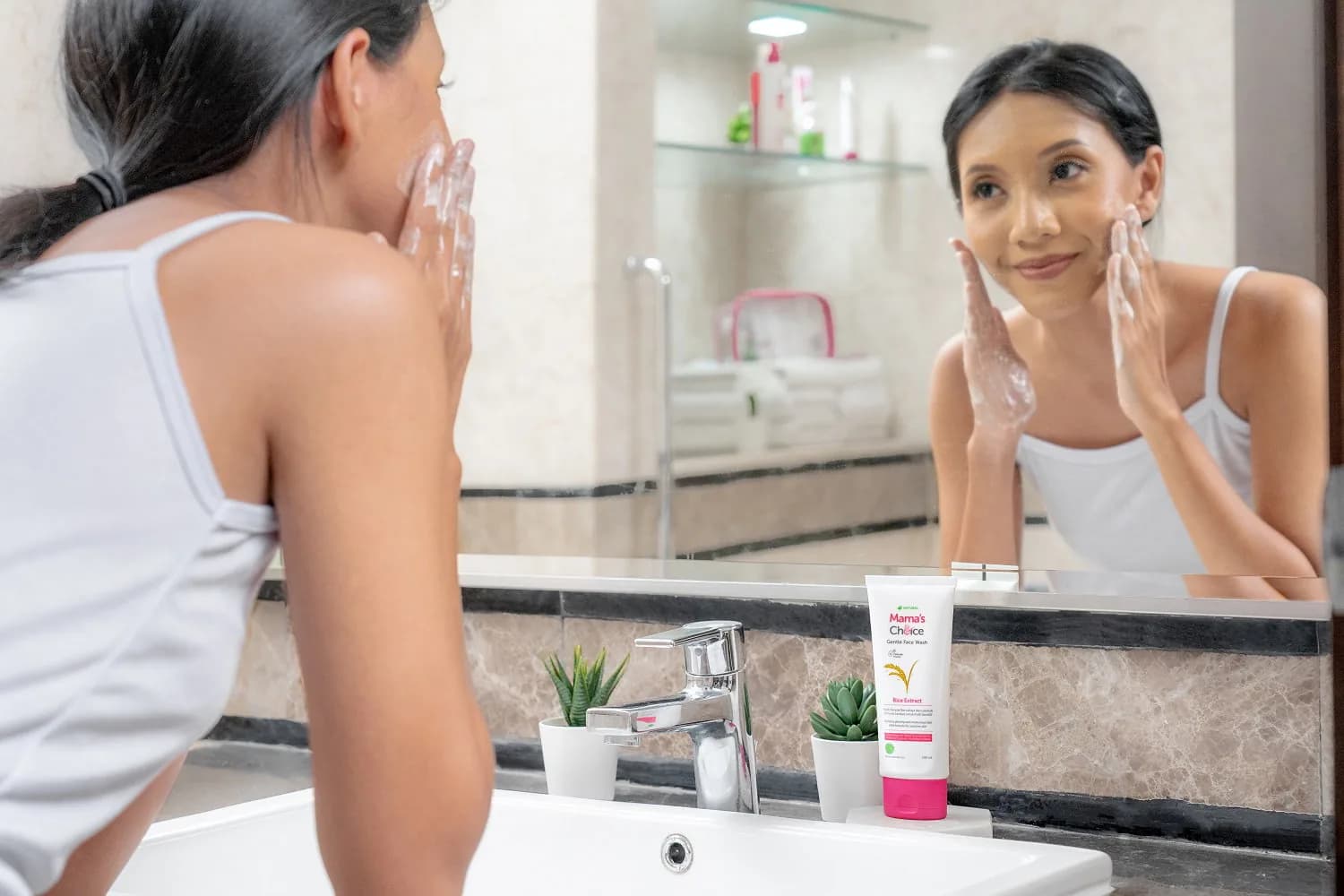 Face wash and a towel beside a basin