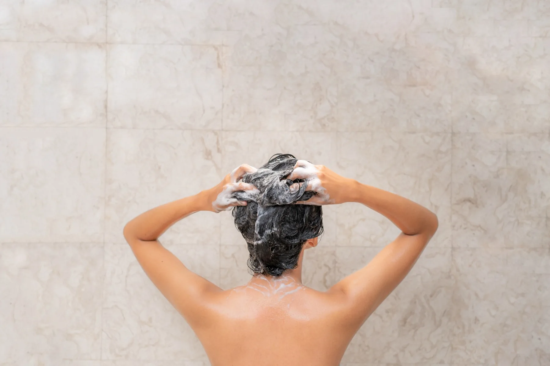 Washing hair with shampoo, seen from above