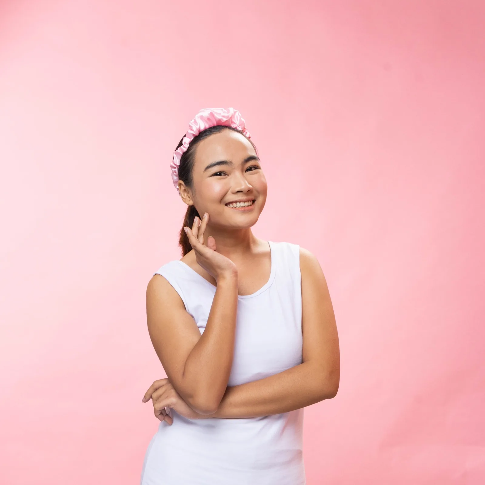 Mama in a headband, touching her cheek