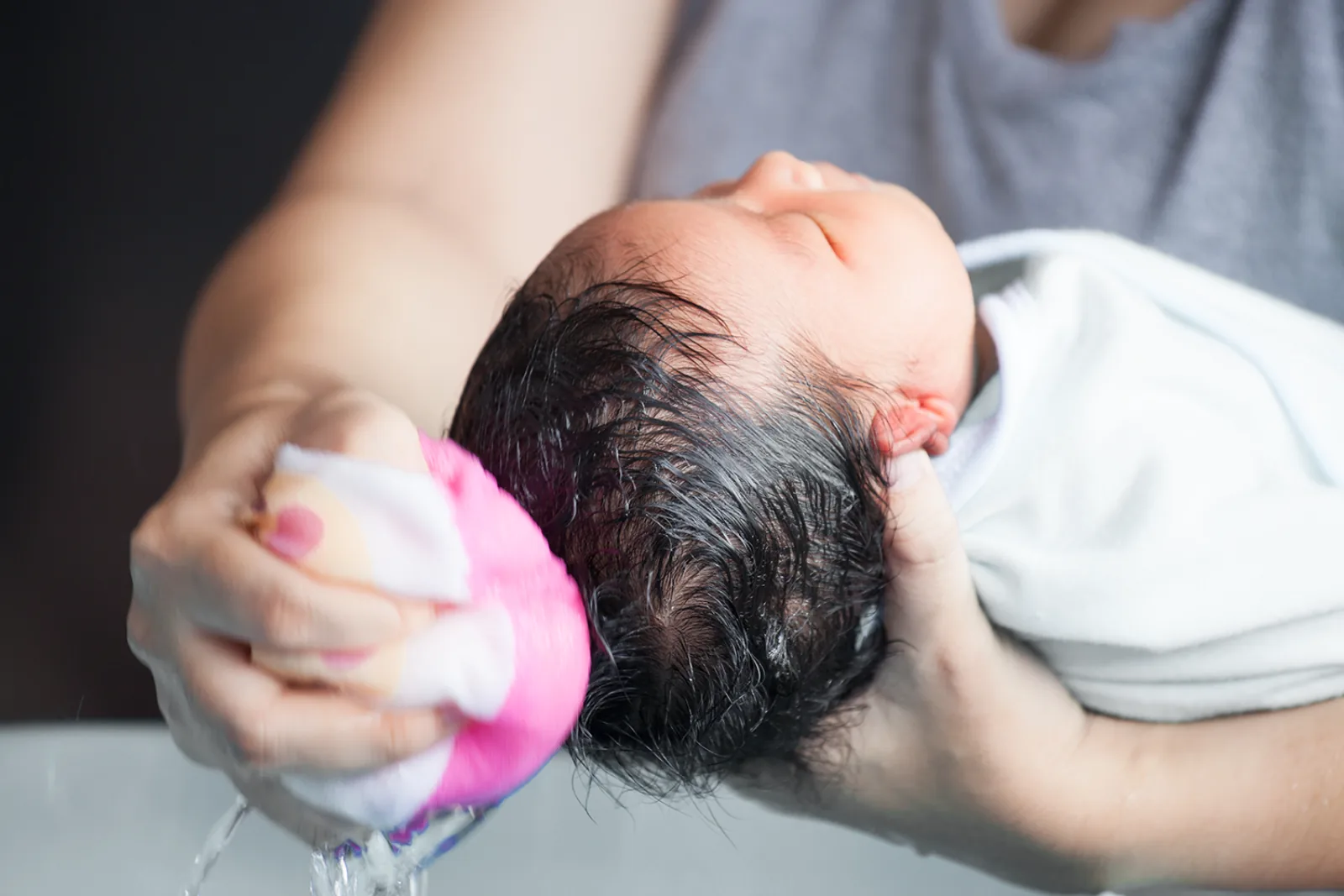 A newborn being gently cleaned
