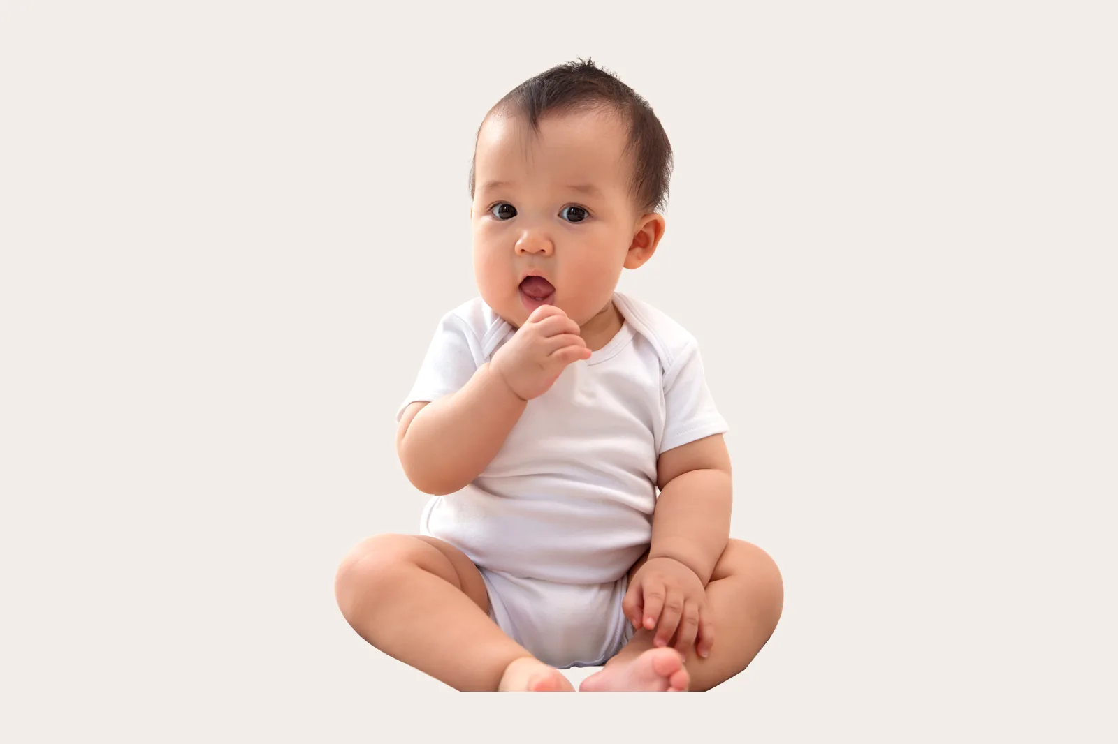 Bayi duduk sambil memegang makanan