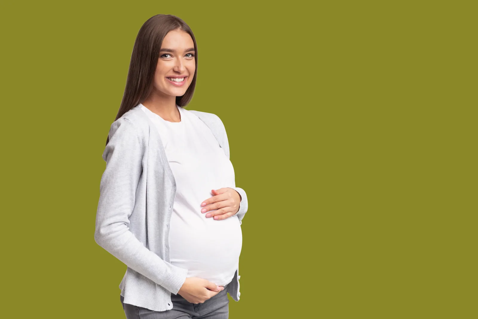 Pregnant woman against a green background