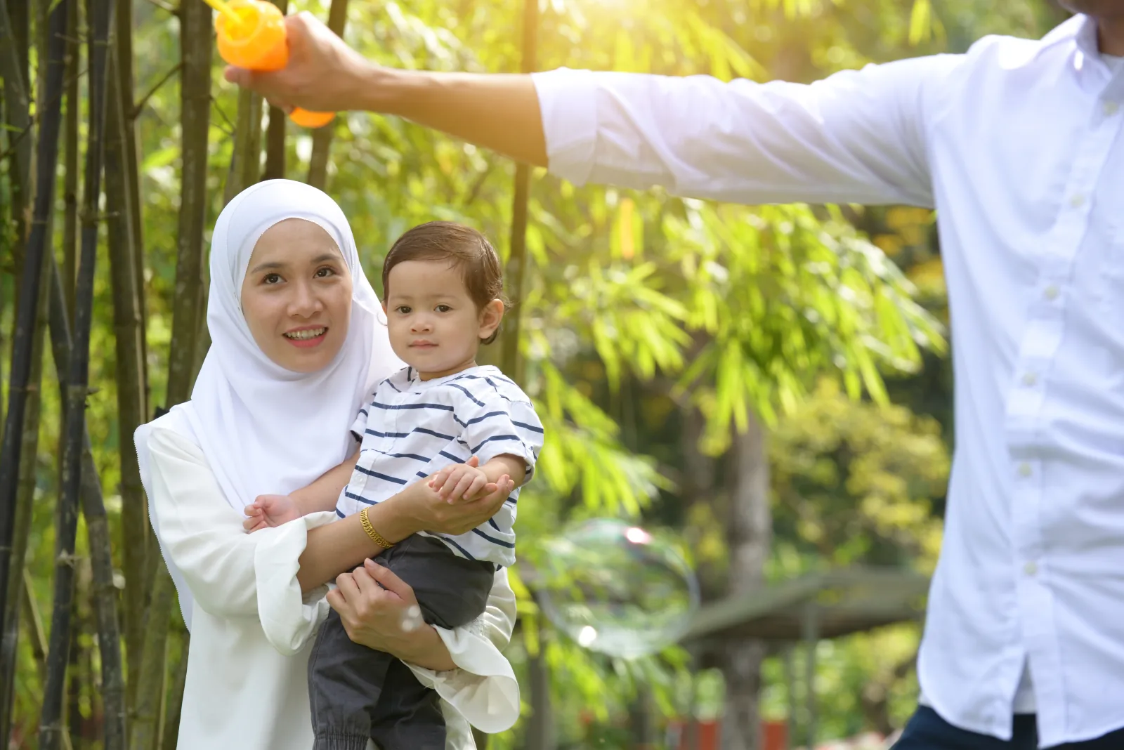 Keluarga berhijab berjalan di luar ruangan