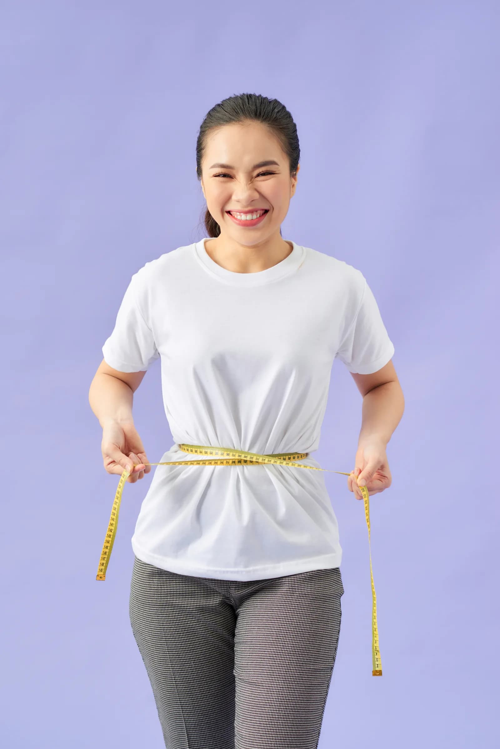 Woman measuring her waist