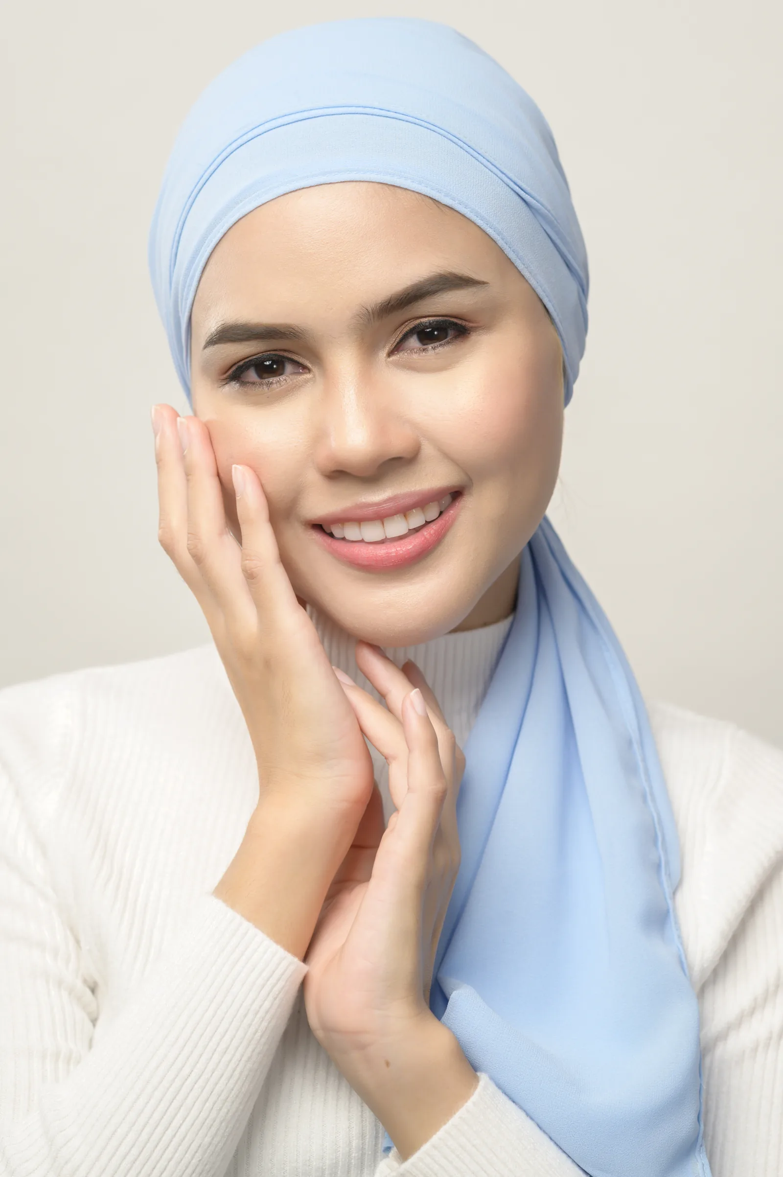 A woman in a hijab in front of a mirror
