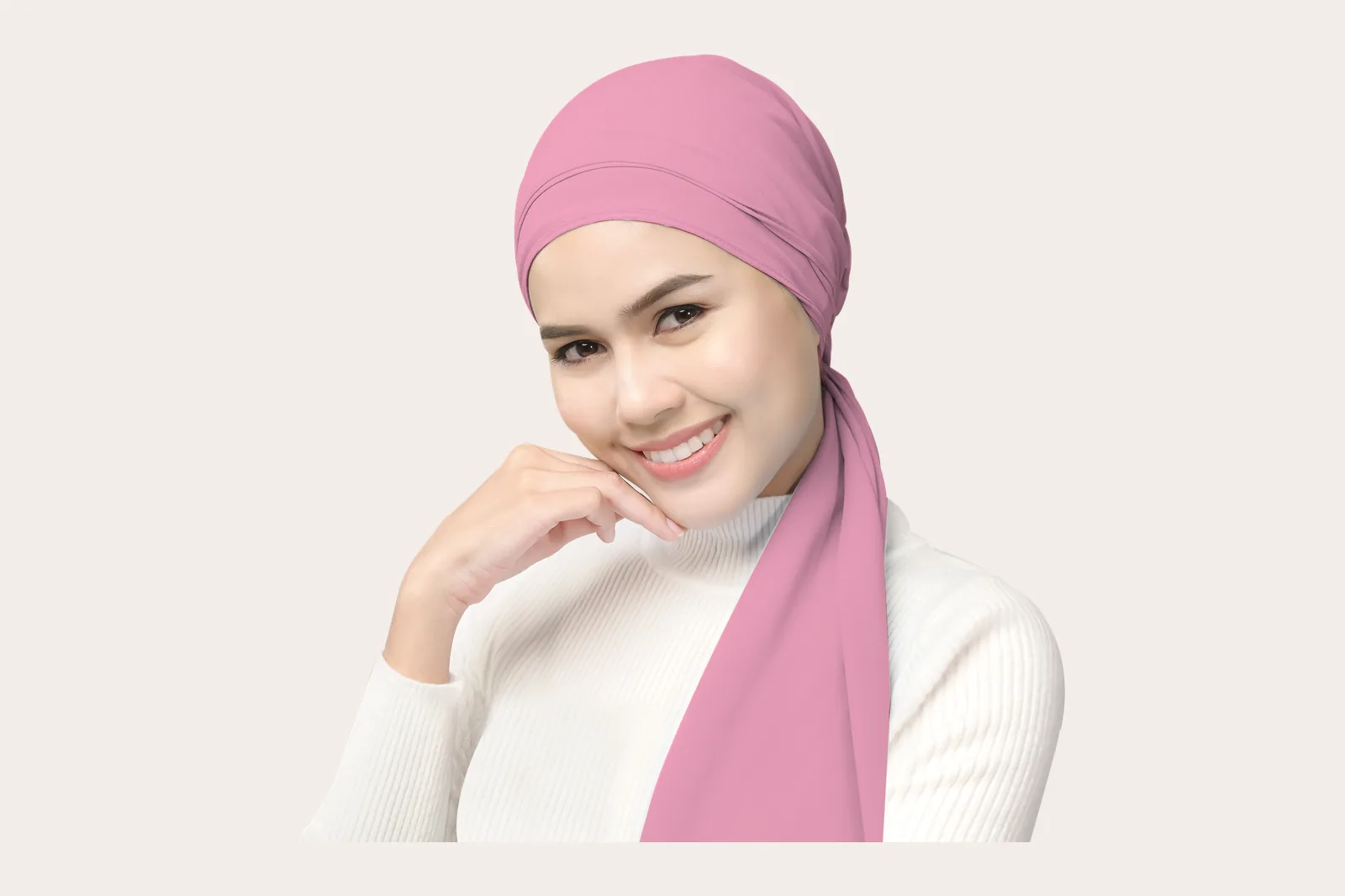 Woman in a hijab applying skincare