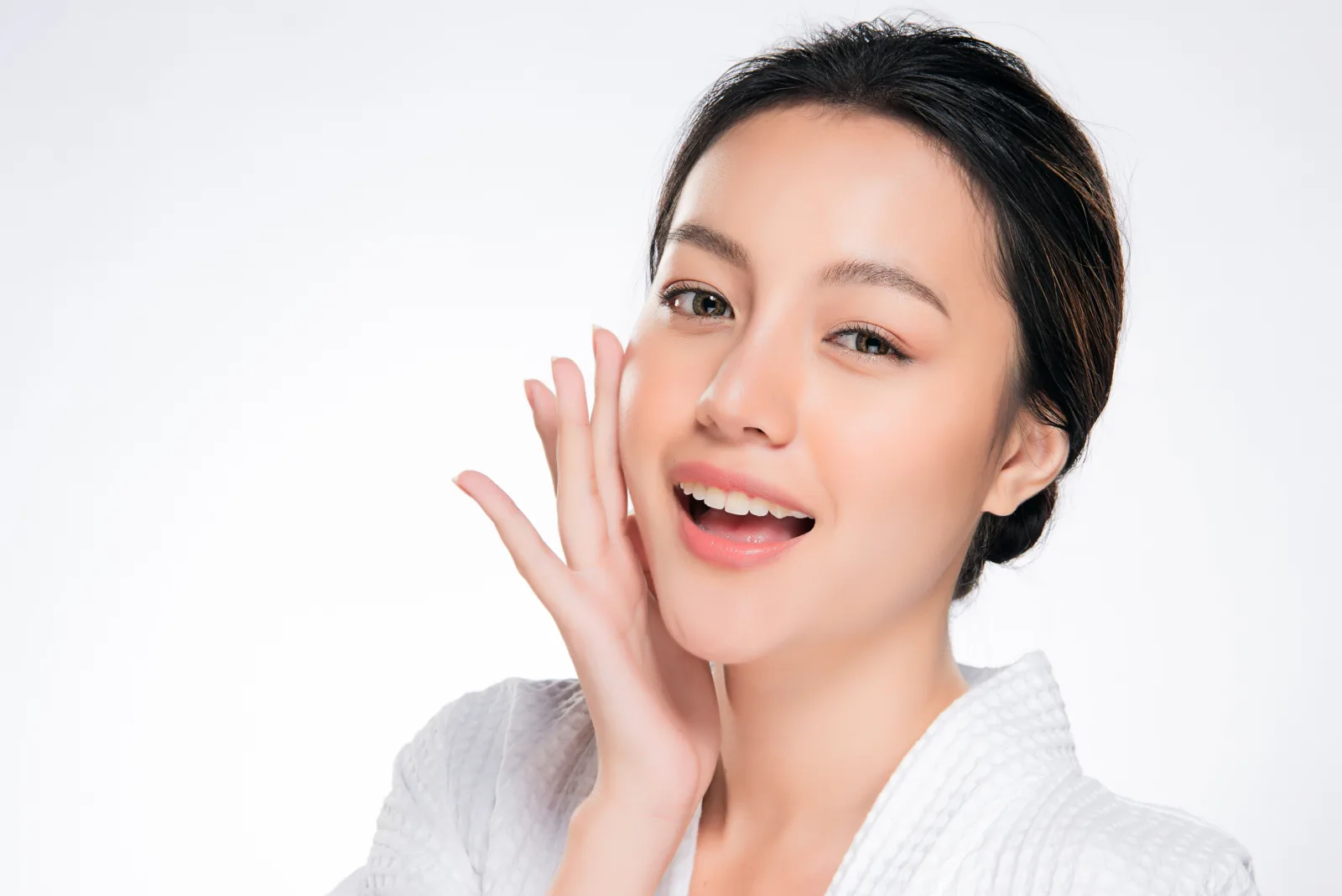A woman applying body care after a shower